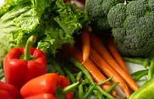Raw vegetables - lettuce, tomatoes, broccolli, carrots, green beans, and red peppers.