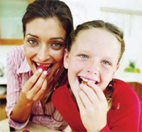 Mother and daughter eating strawberries