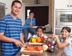 Photo of a family cooking in the kitchen.