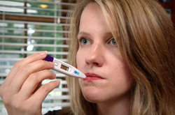 Woman taking her temperature.