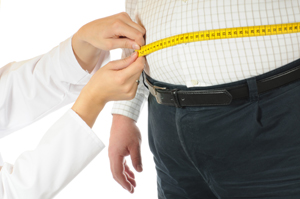 Nurse measuring a patients waist with a tape measure