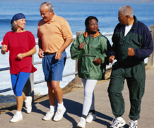 Four middle-aged people (2 men and 2 women) walking.